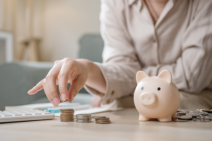 Fiscal financial management. Money government budget. Economic. Tax management. A woman is putting coins into a piggy bank. Concept of saving money. Fiscal monetary government.