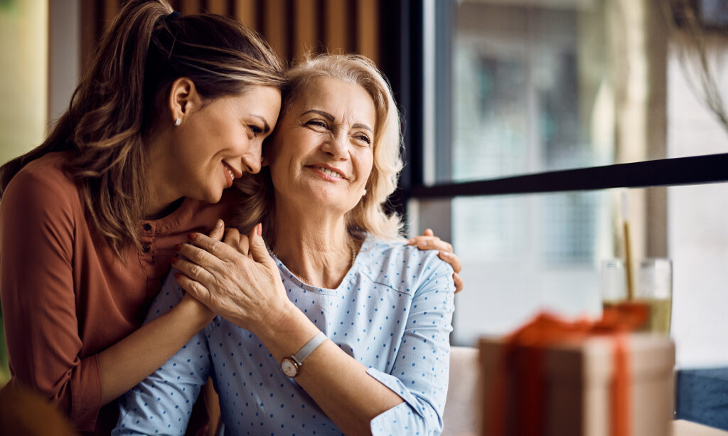 Woman Hugging Mother Lovingly