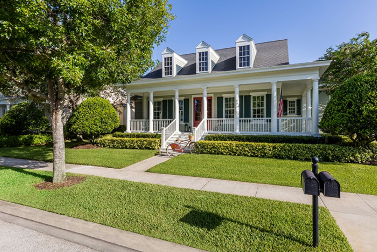 Street view of white house with Renewal By Anderson windows and entry doors