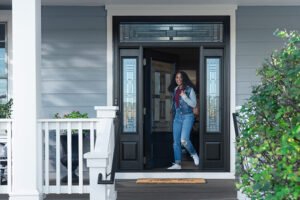 Woman coming out of Renwal By Andersen Ensemble Entry Door