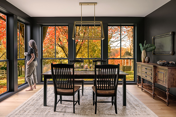 Woman standing with Coffee in front of large double hung window by Renewal by Andersen